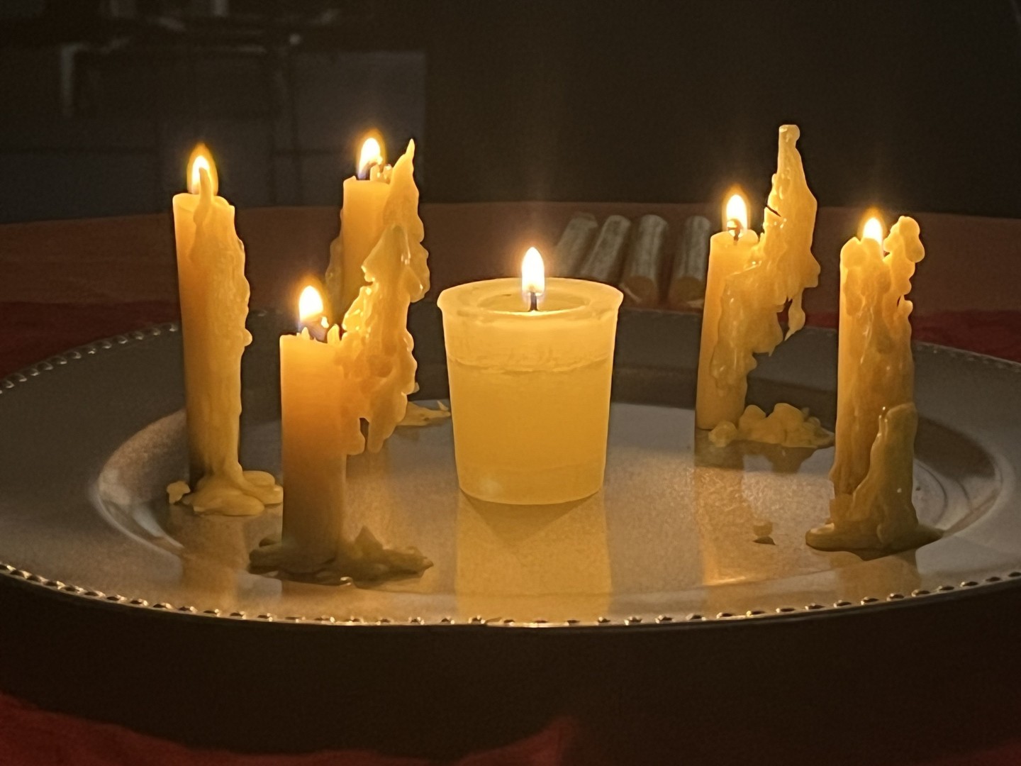 Five small candles of blessings around a large central candle.