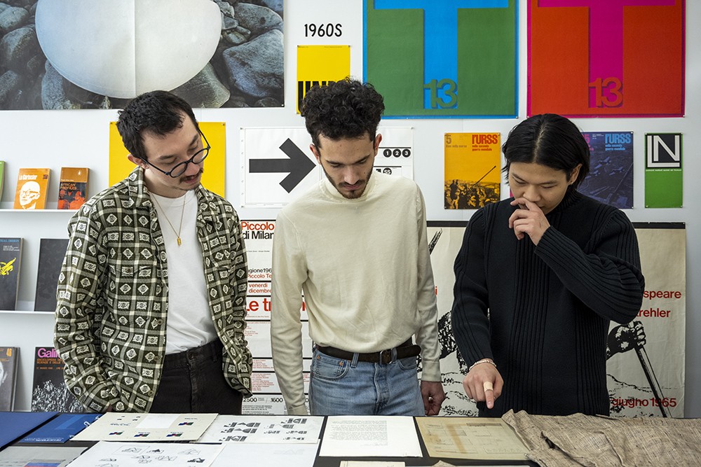 Three students look at Vignelli Center artifacts.