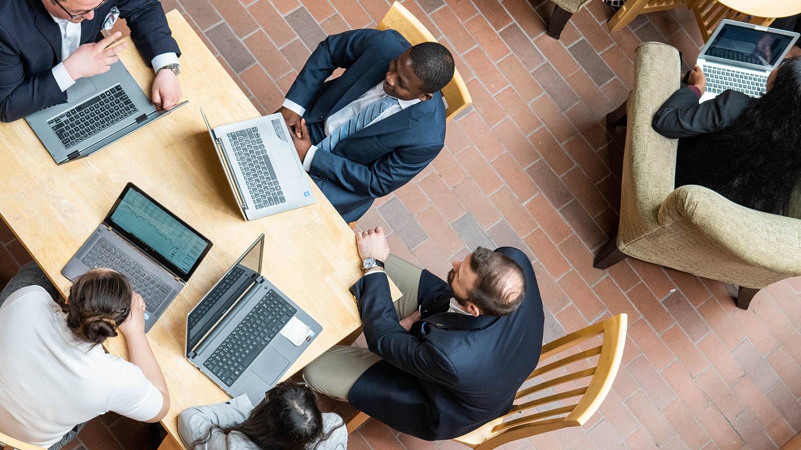 overhead image of people working at talbes