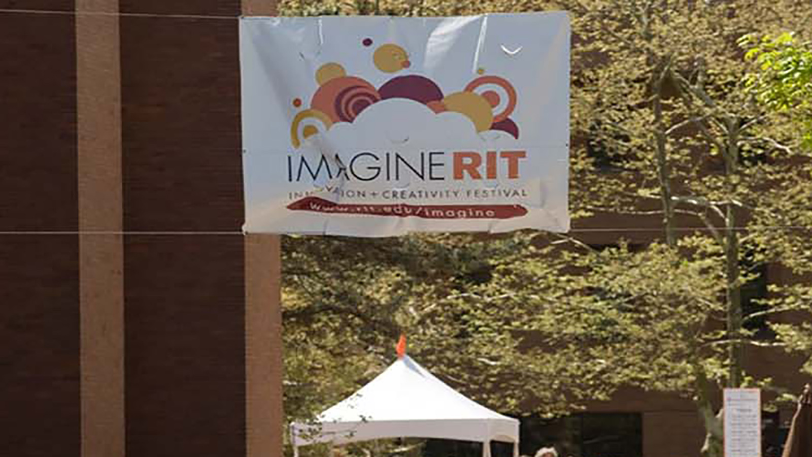 A crowd of people walking the Quarter Mile during Imagine RIT