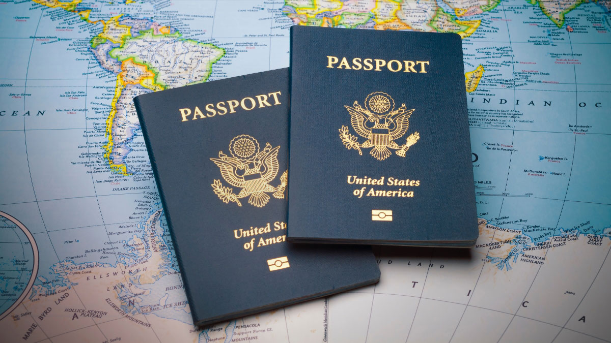 Two United States passports placed on a world map, symbolizing travel and international exploration.