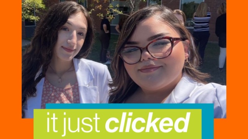 Two students in white lab coats