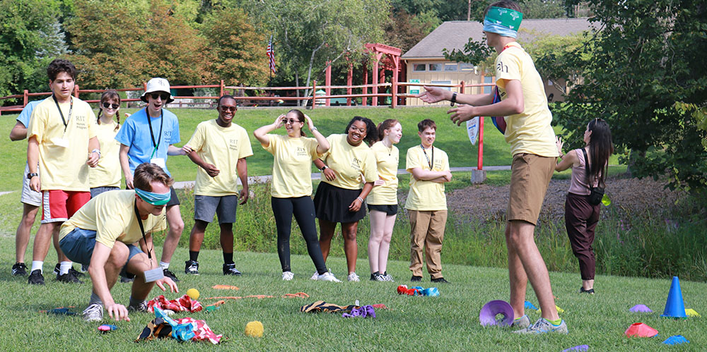 Honors students in yellow tshirts playing yard games during orientation