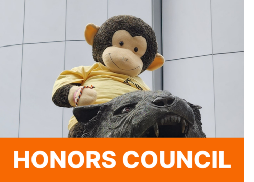 Photo of Stanley in a yellow Honors program t-shirt on the Ritchie statue; Honors Council in white text in an orange box along the bottom