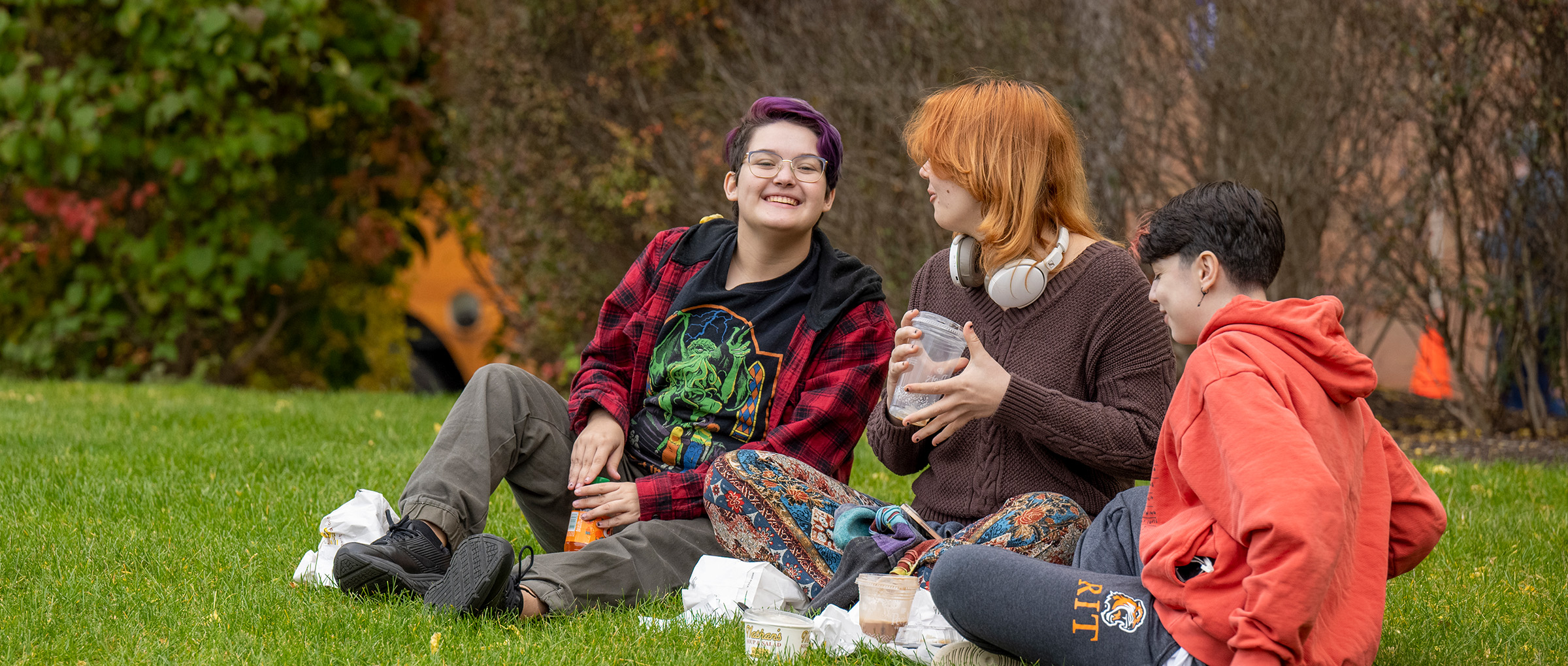 students in grass laughing