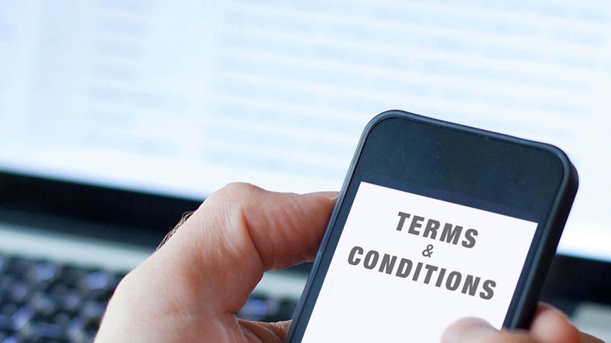 Close-up of a smartphone showing the terms and conditions, emphasizing important legal information for users.