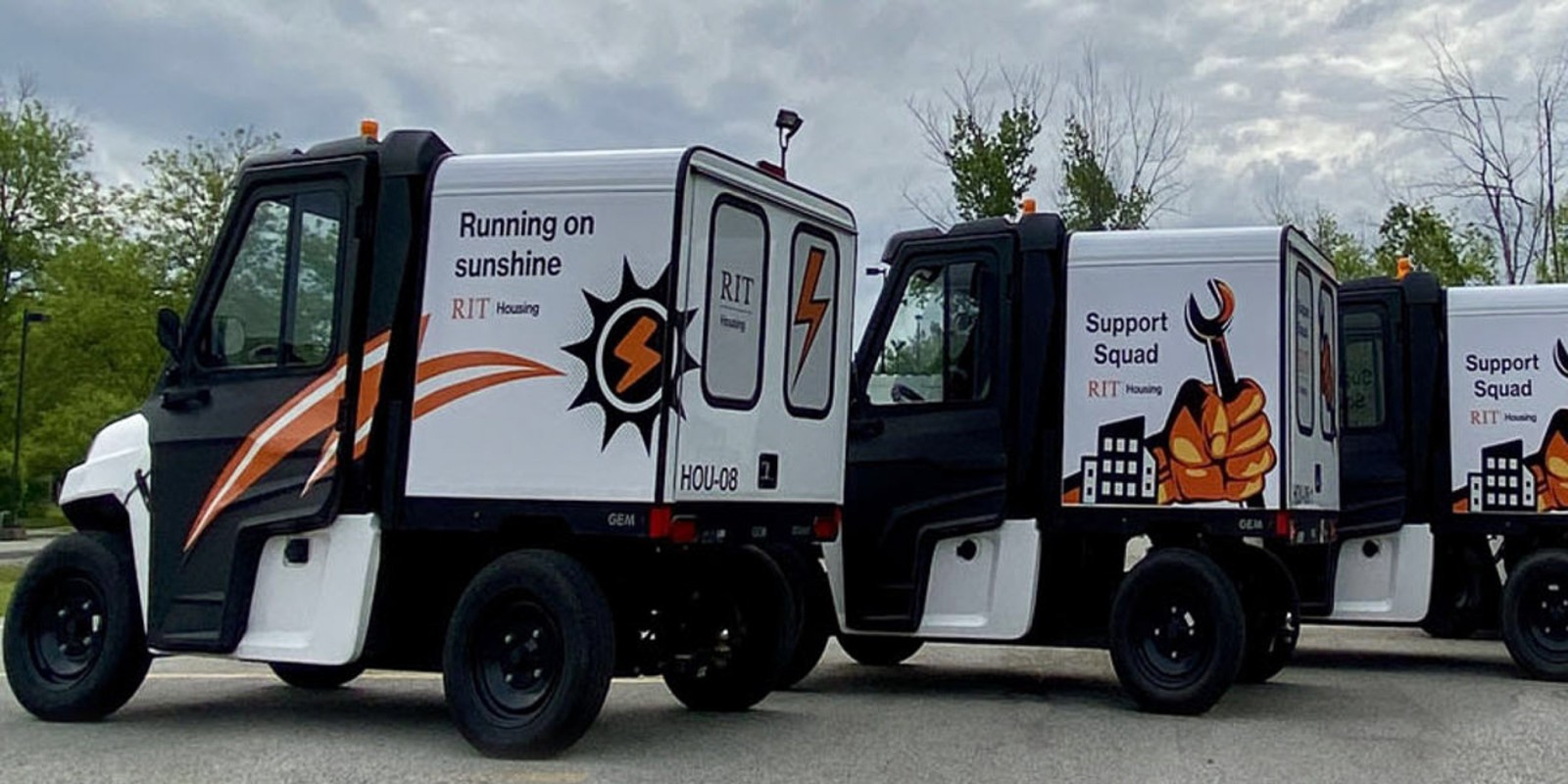 ﻿Three RIT Housing golf cart-sized trucks side by side