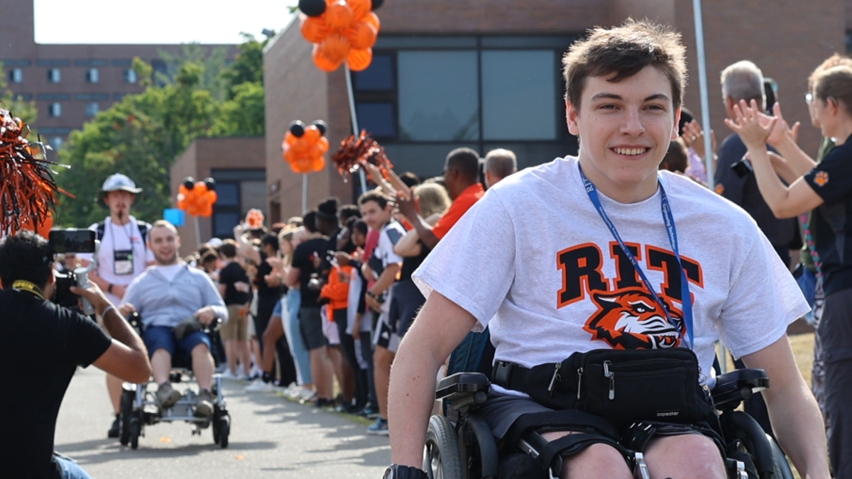 two students who use wheelchairs making their way down the quarter mile during tiger walk ceremony