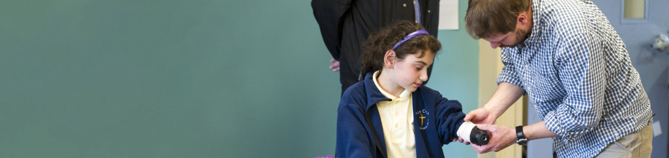 A researcher fitting a prosthetic onto a volunteer.