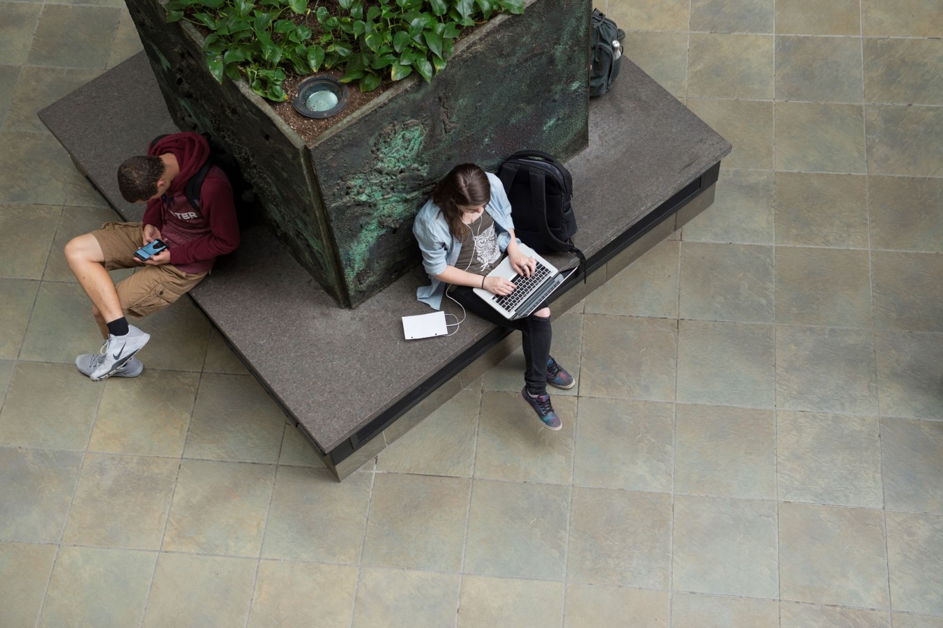 aerial view of students sitting on decorative benches in GCCIS atrium