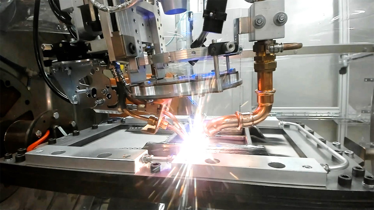 Robotic welding, with a bright light and sparks.