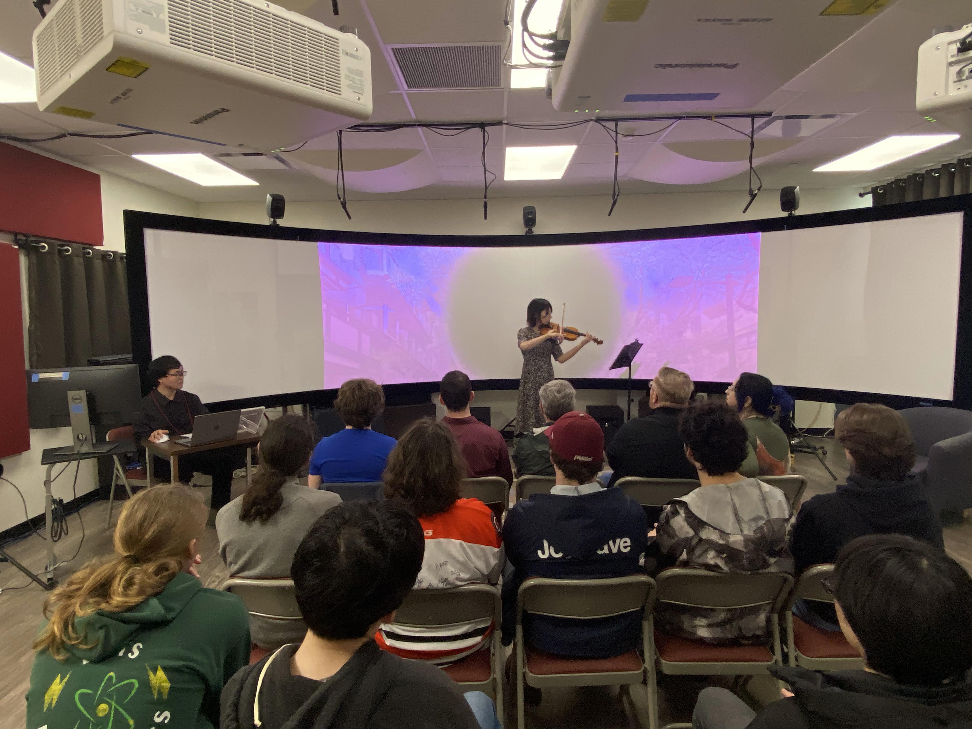 PhD student Akira Takeuchi and guest violinist Yuki Inagaki perform a piece of spatialized music.