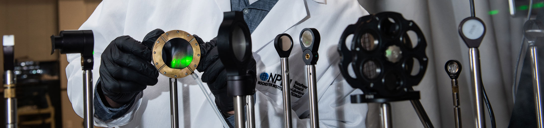 A researcher adjusting equipment (lenses and sensors) as part of an experiment.