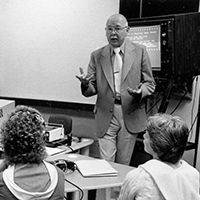 B/W photo of Ed Scouten teaching in front of students