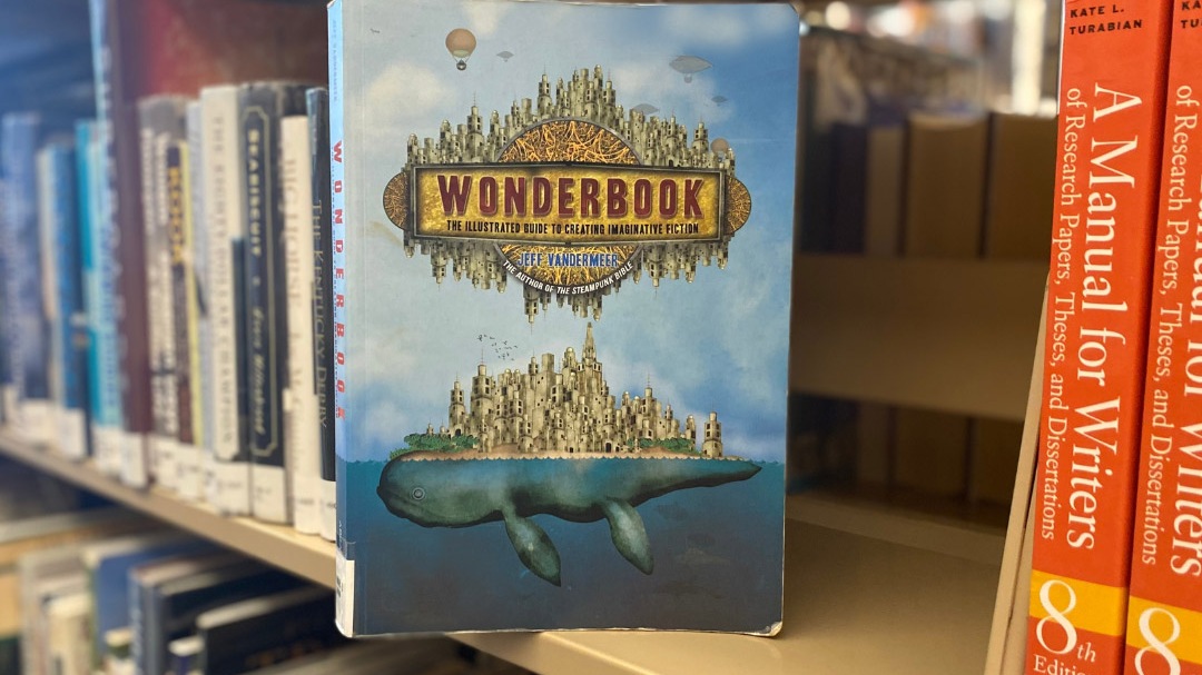 The book, "Wonderbook" sits on a library shelf.