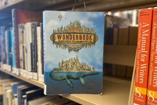 The book, "Wonderbook" sits on a library shelf.