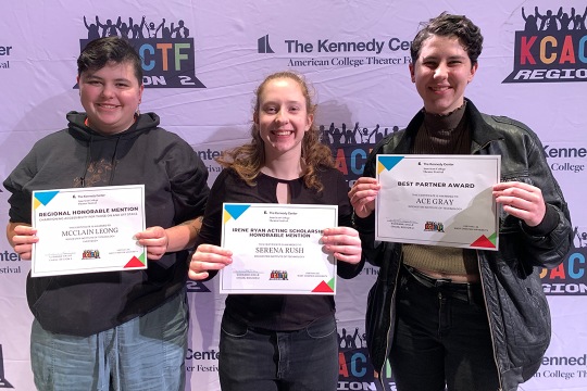 three college students holding award certificates