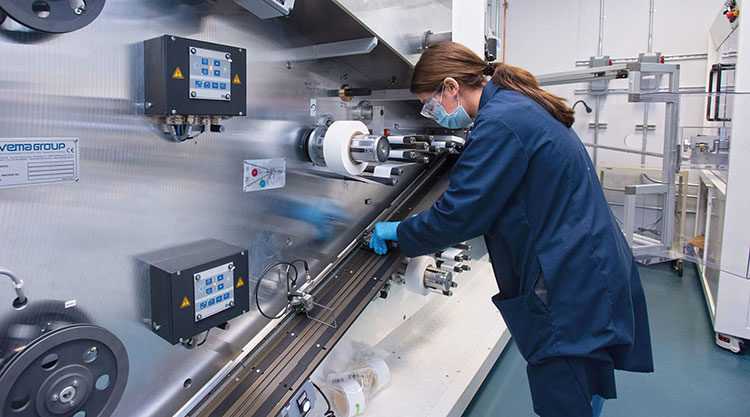 A group of students wearing masks using a cordless drill.