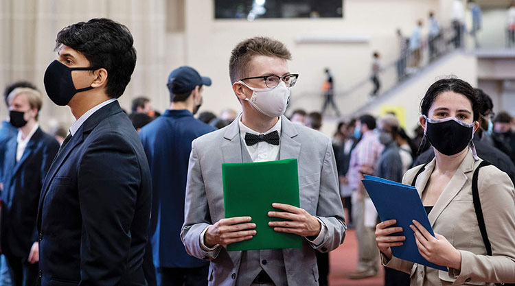 A group of students wearing masks using a cordless drill.