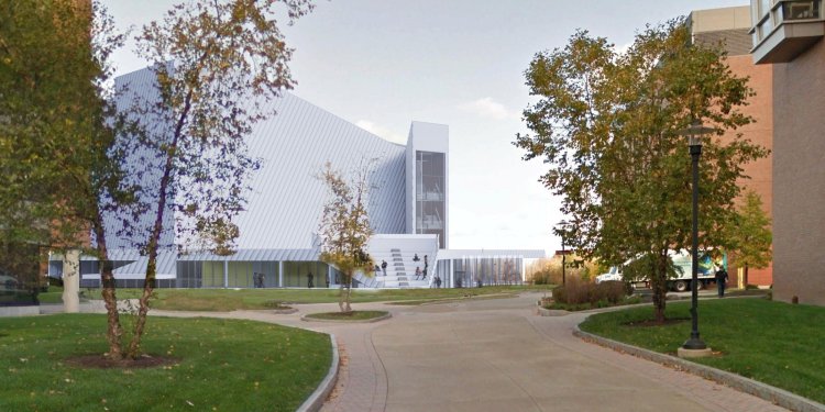 A group of students wearing masks using a cordless drill.