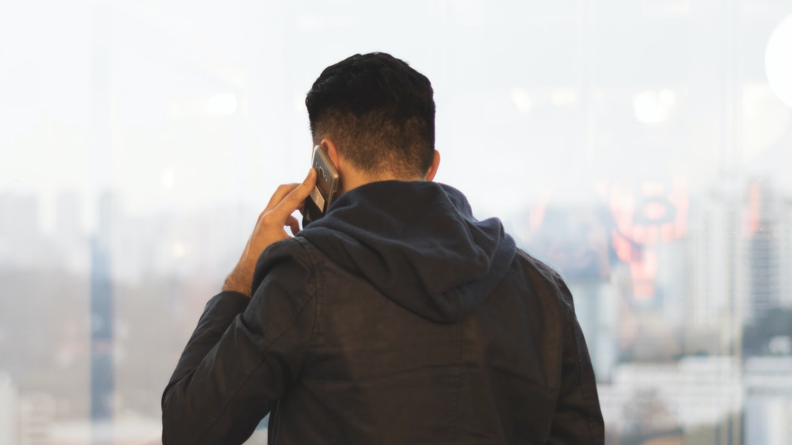 Man speaking on the phone reporting a safety concern.