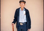 A man with a cane poses for a photo.
