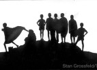 A panoramic silhouette of people and animals.
