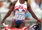 A runner holds the American flag.
