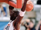 Michael Jordan dunks a basketball.