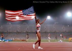 A runner celebrates with the American flag.