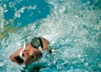 A close up face shot of a swimmer during a race.