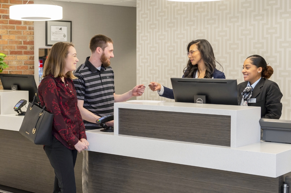 A couple checking in at the concierge desk