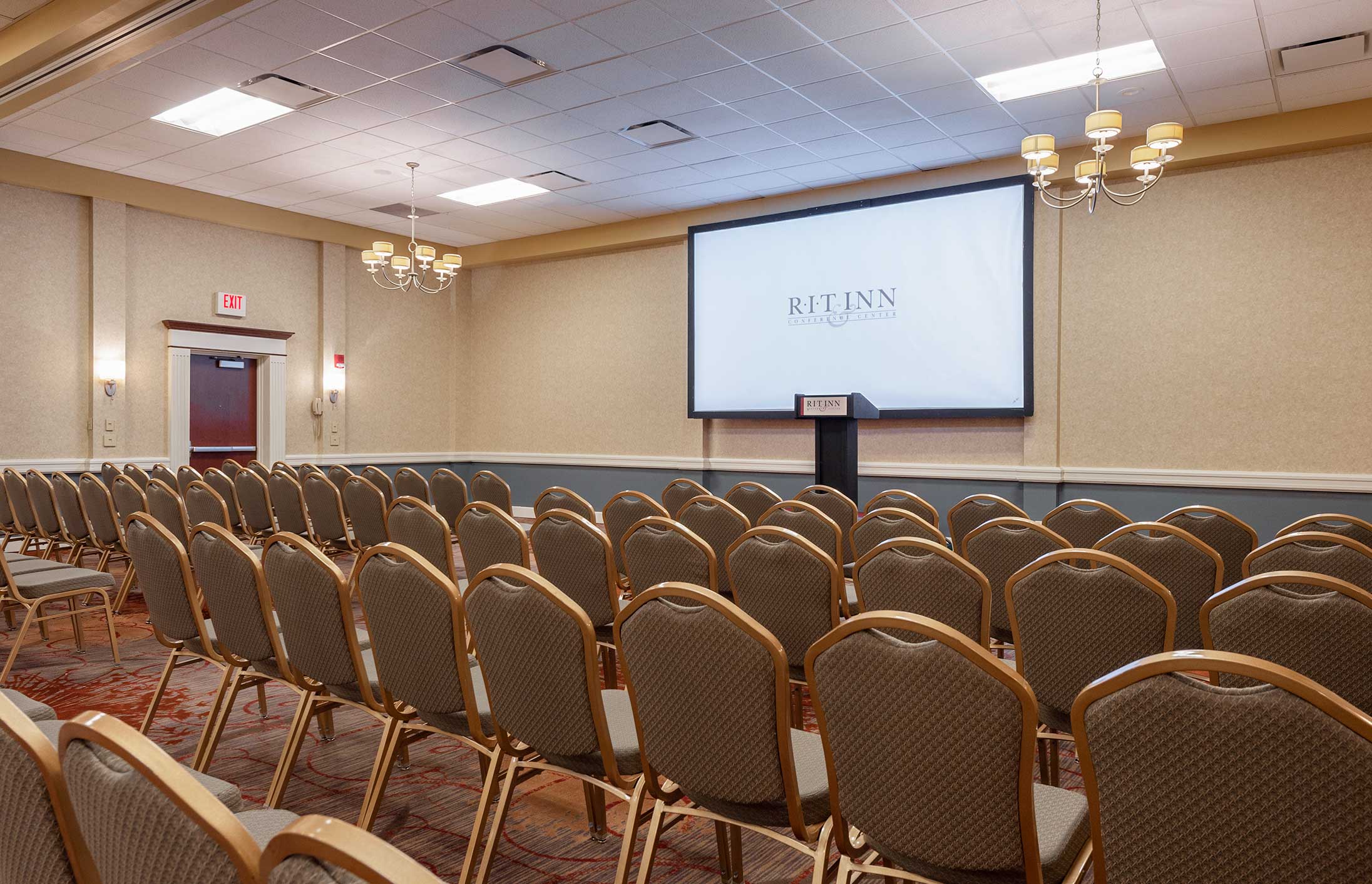 Conference room filled with chairs and a projector 