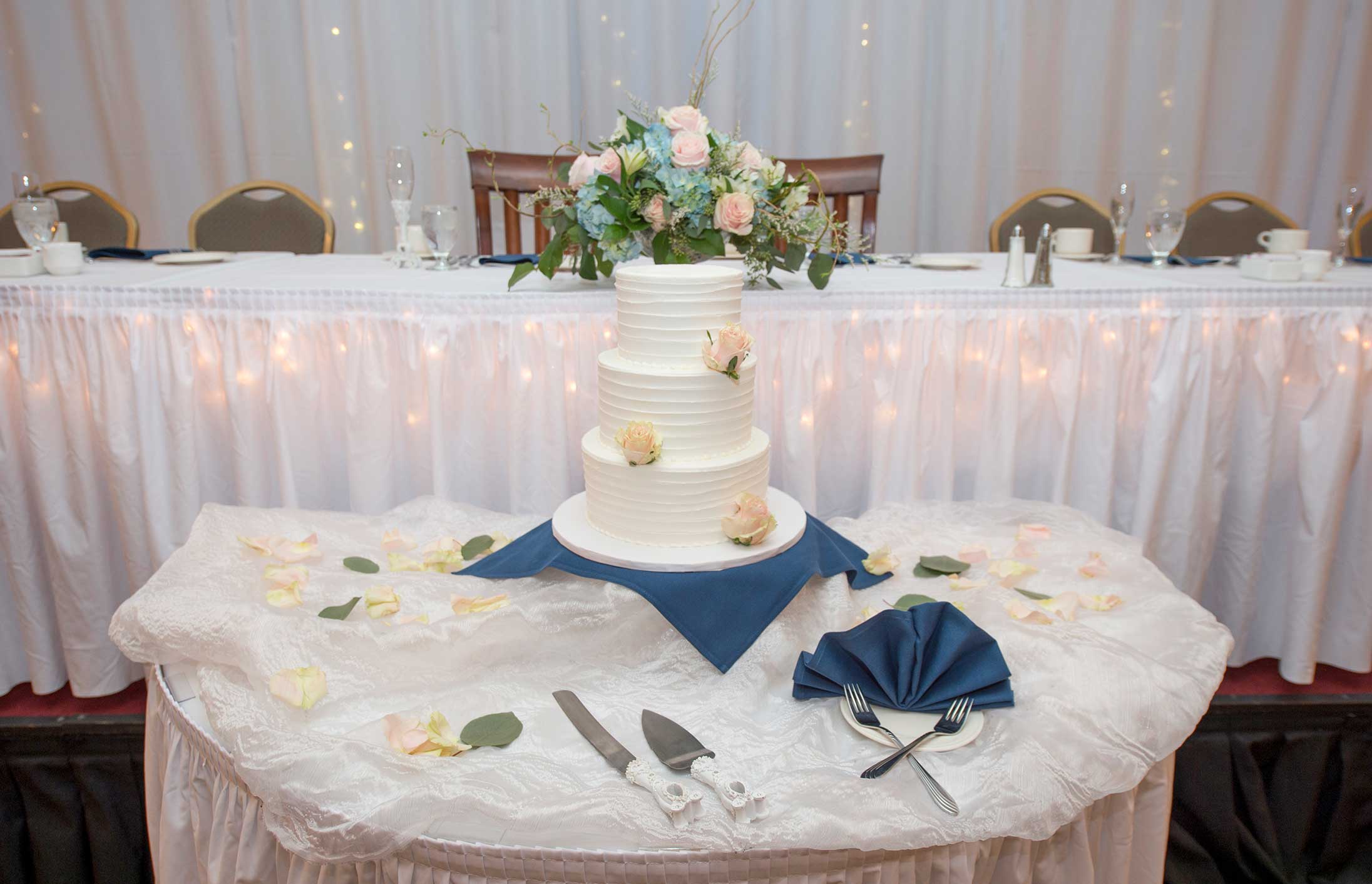 Wedding cake in front of the bridal party table