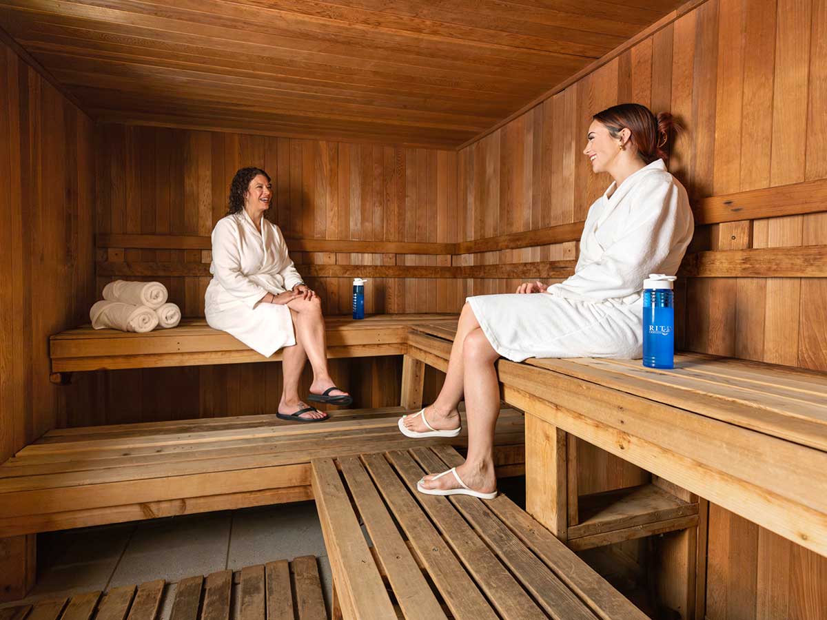 Two people sitting in a sauna