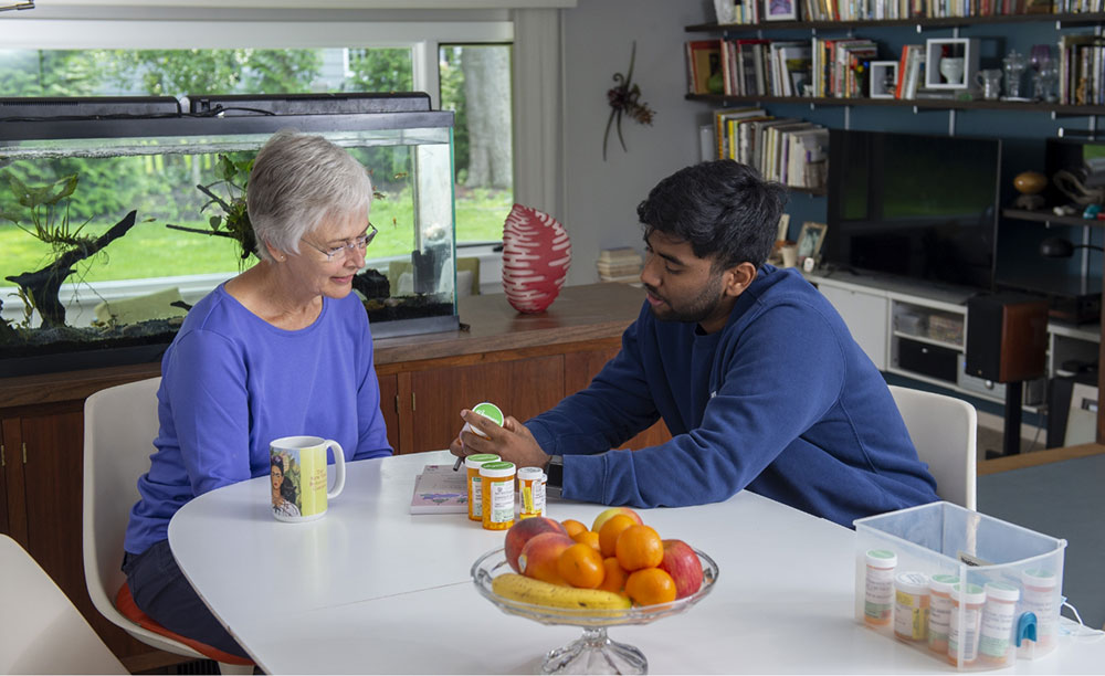 a health coach speaking with another person at a table