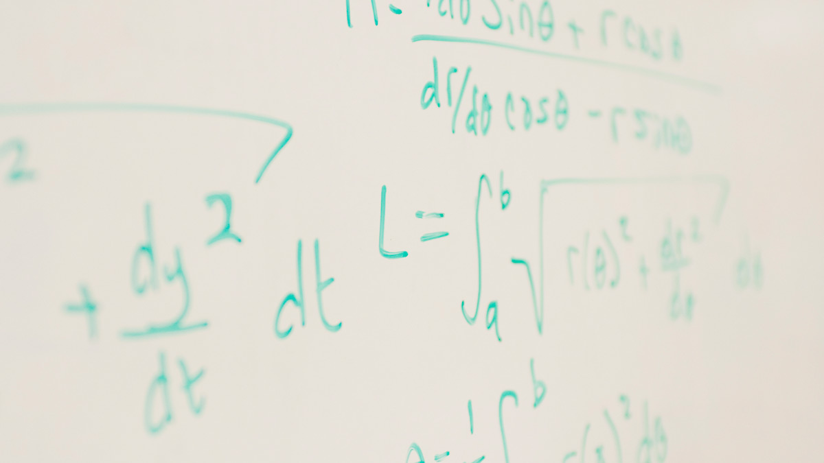 Formulas written in green marker on whiteboard.