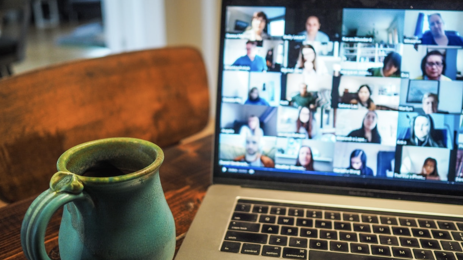 Macbook pro displaying group of people on zoom class