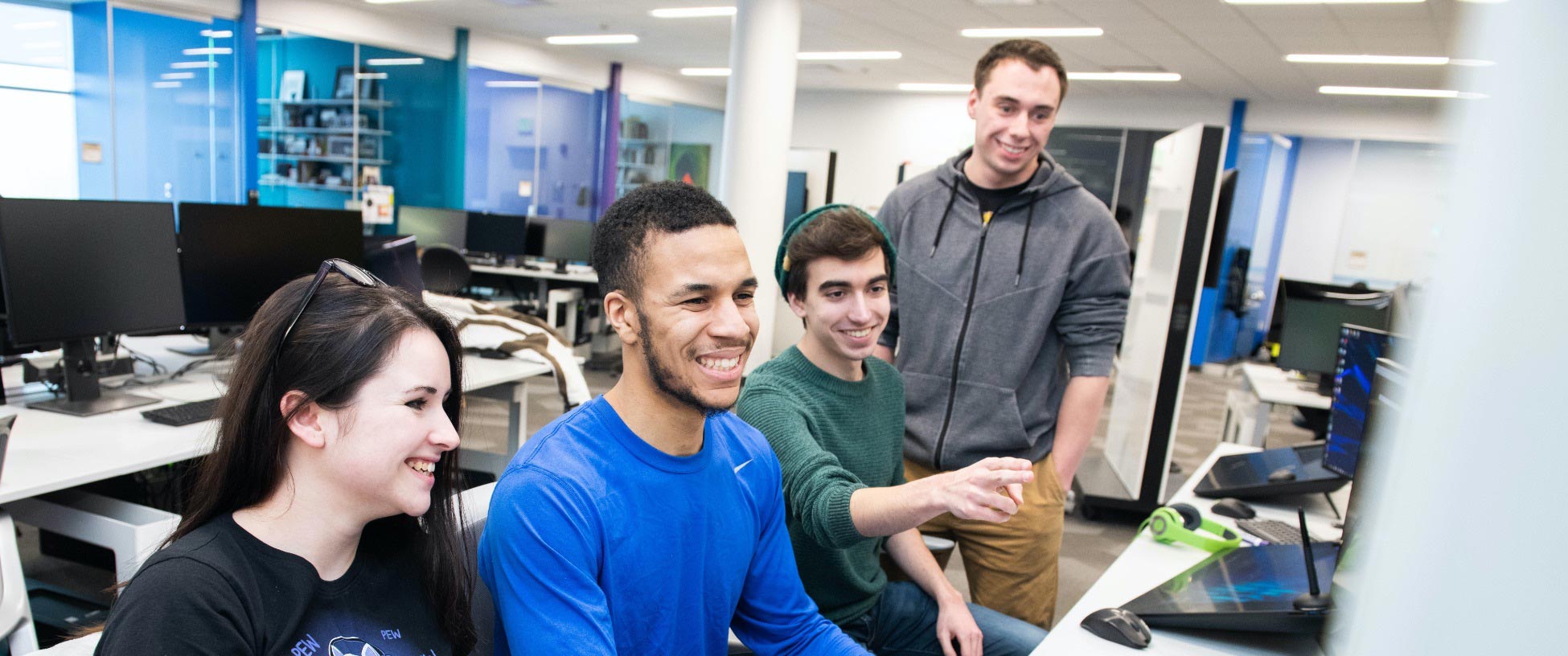 Students in a computer lab work together on a project.