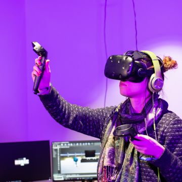 Purple hue image with a user wearing VR goggles