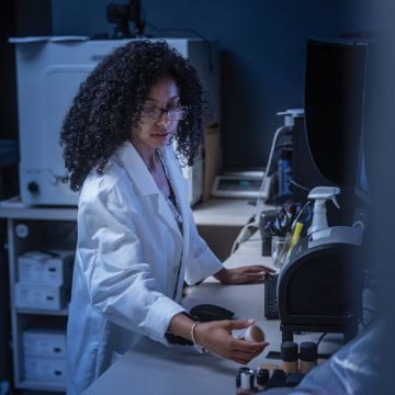 Woman in a lab wearing a white coat