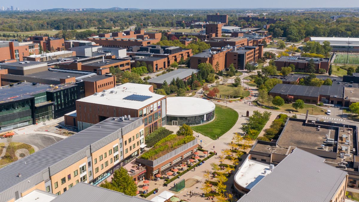 Aerial view of the Rochester Institute of Technology campus, showcasing modern brick buildings and green spaces.