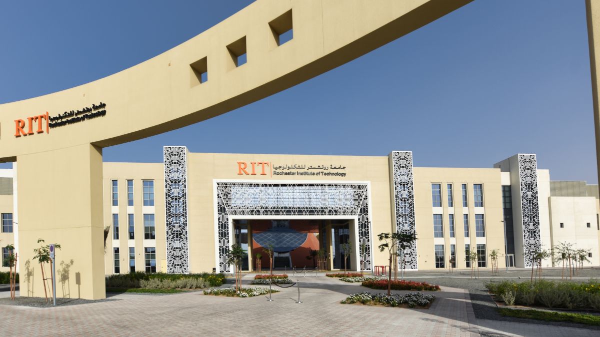 Entrance of the R I T Dubai campus, featuring Arabic architectural patterns and a large archway.