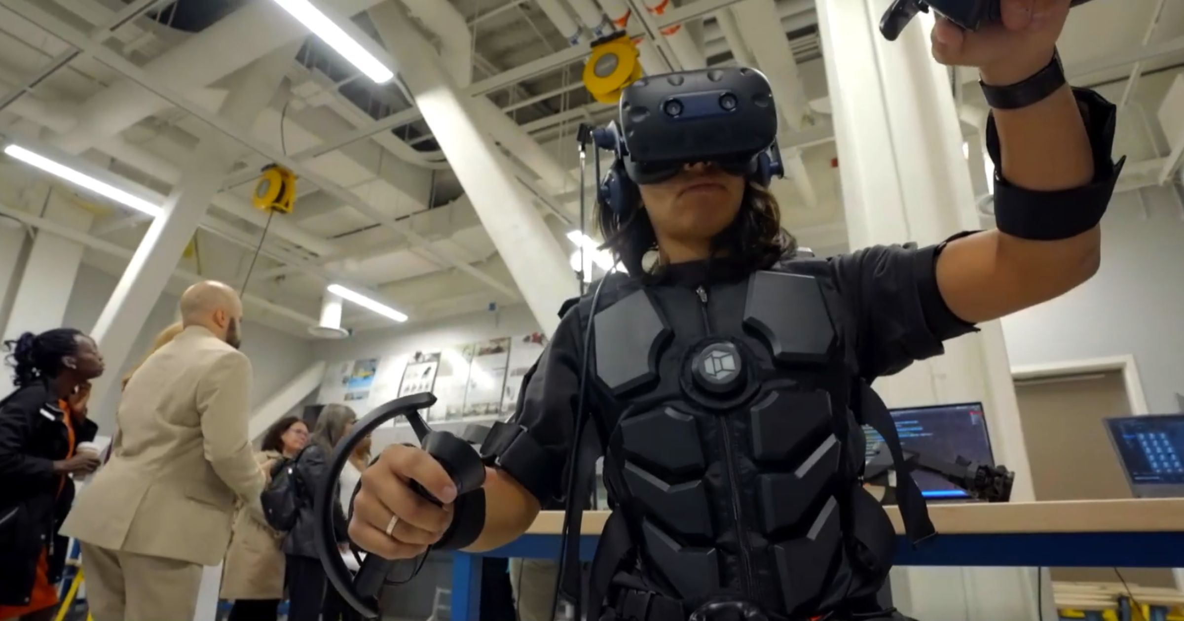 Person wearing VR vest, gloves, and headset