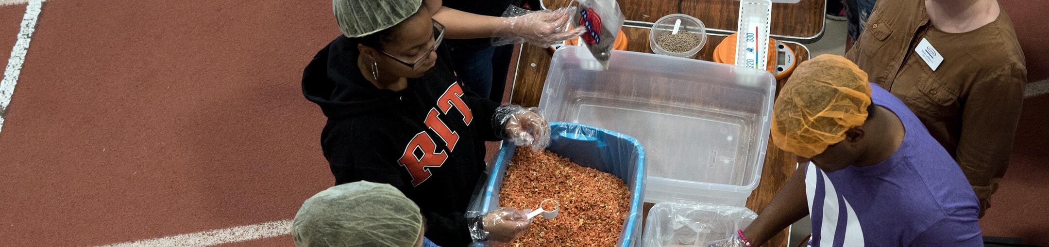 R I T students helping prepare meals