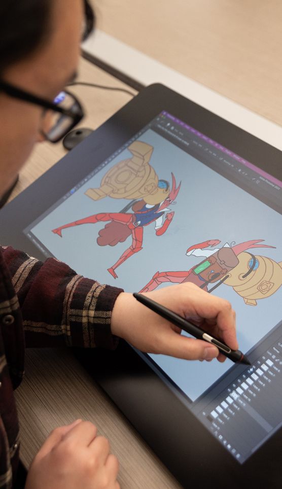 Someone drawing graphics on a digital tablet