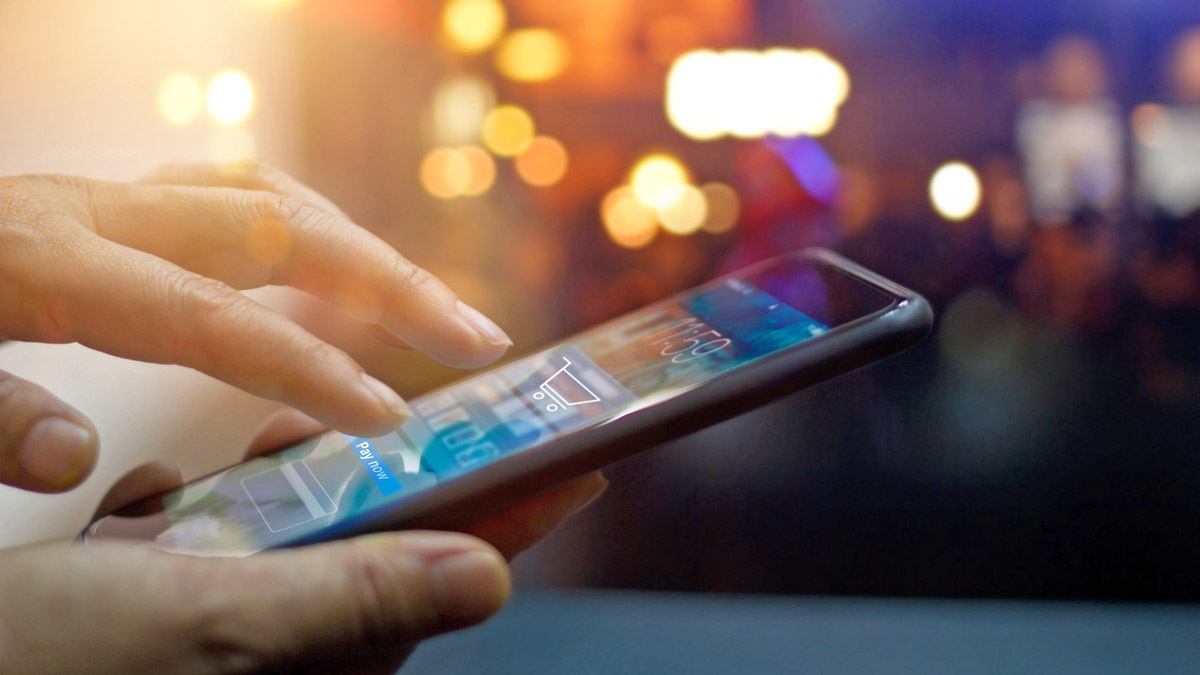 Close up of hand making a payment on smartphone.