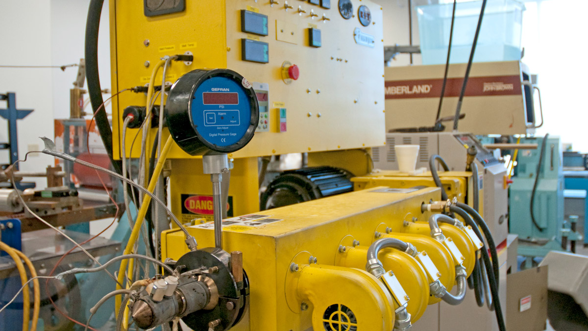 Yellow-painted manufacturing equipment.