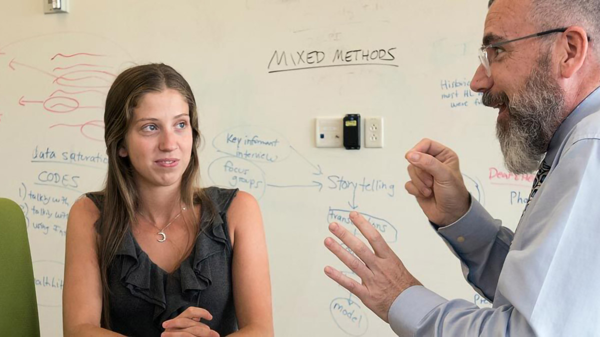 Two people in a room using American Sign Language.