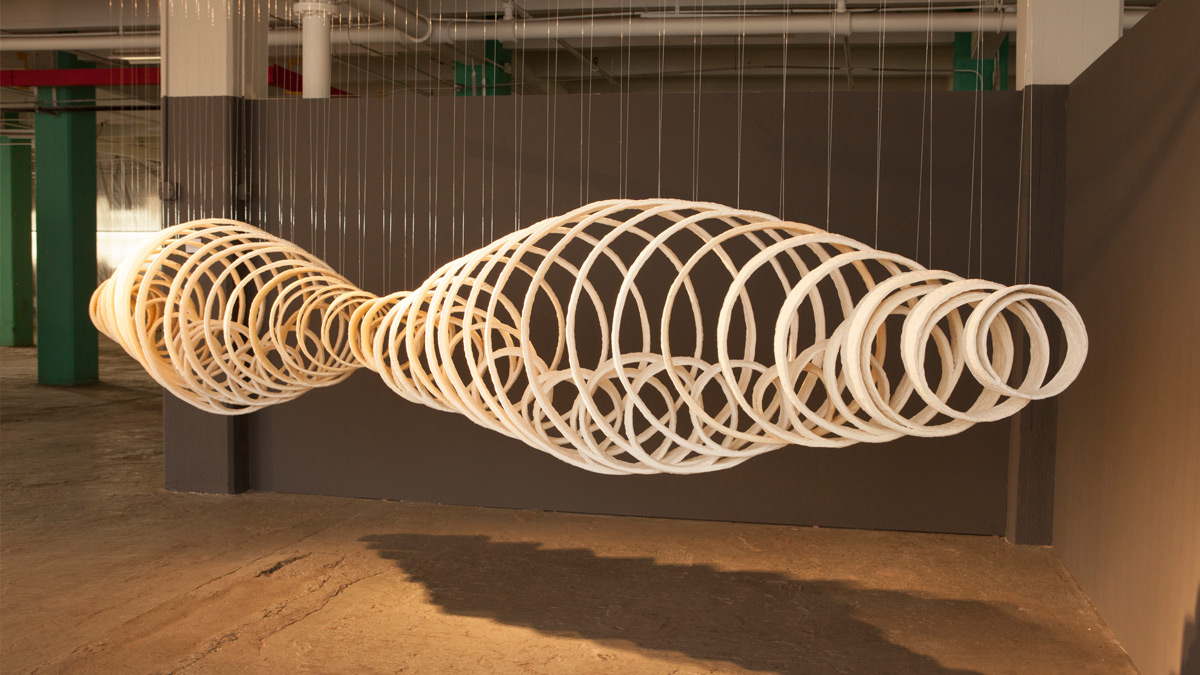 A hanging sculpture of concentric ceramic rings.